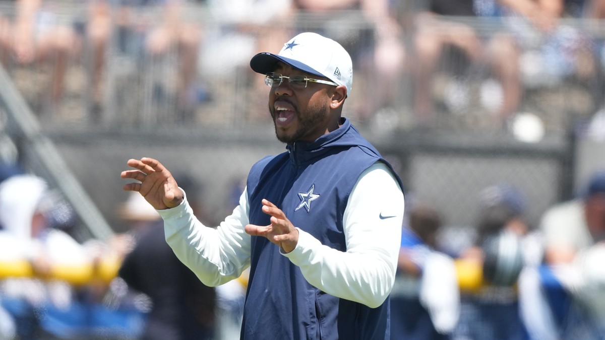 Cowboys defensive coordinator Christian Parker gestures with both hands as he calls out instructions at practice.