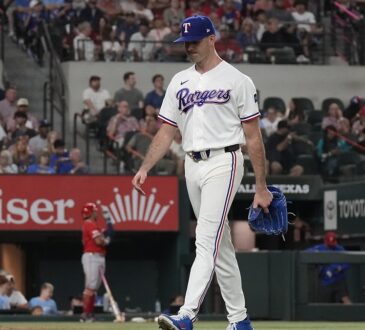 Texas Rangers pitcher Cody Bradford walks off the mound carrying his glove after being removed from the game.