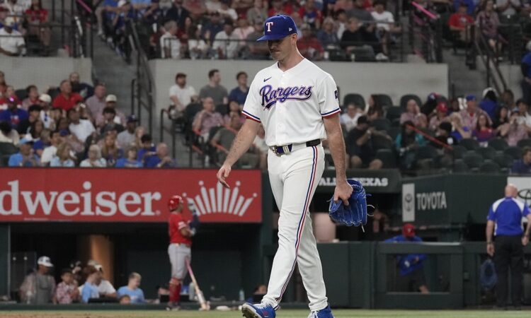 Texas Rangers pitcher Cody Bradford walks off the mound carrying his glove after being removed from the game.