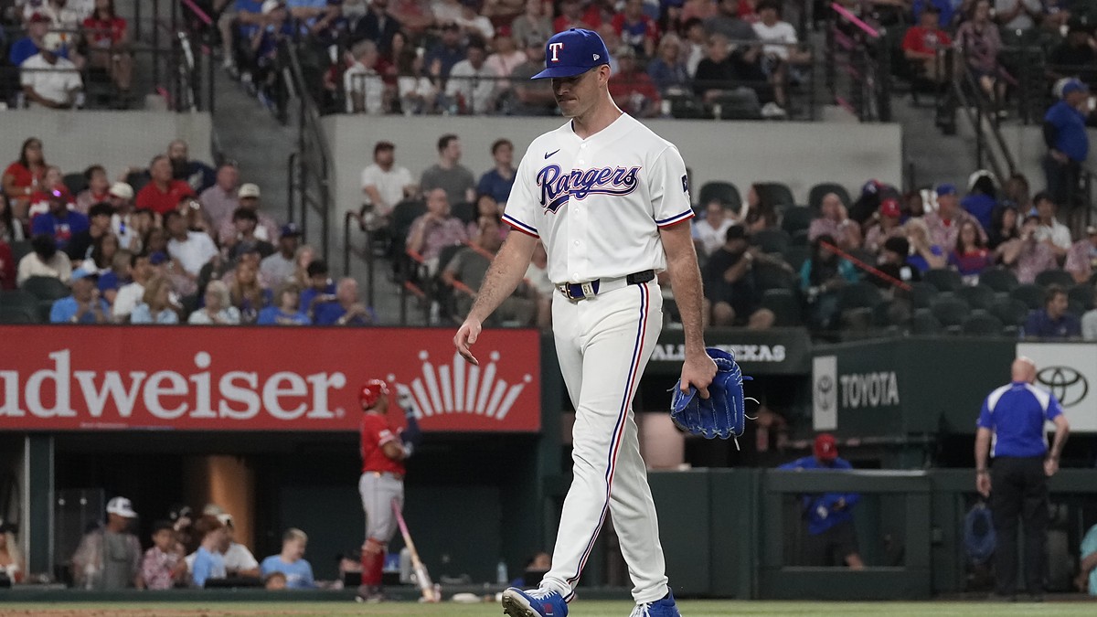 Texas Rangers pitcher Cody Bradford walks off the mound carrying his glove after being removed from the game.