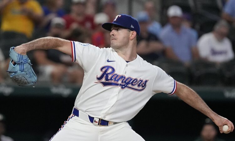 Texas Rangers pitcher Cody Bradford strides toward the plate in his white home uniform at Globe Life Field.