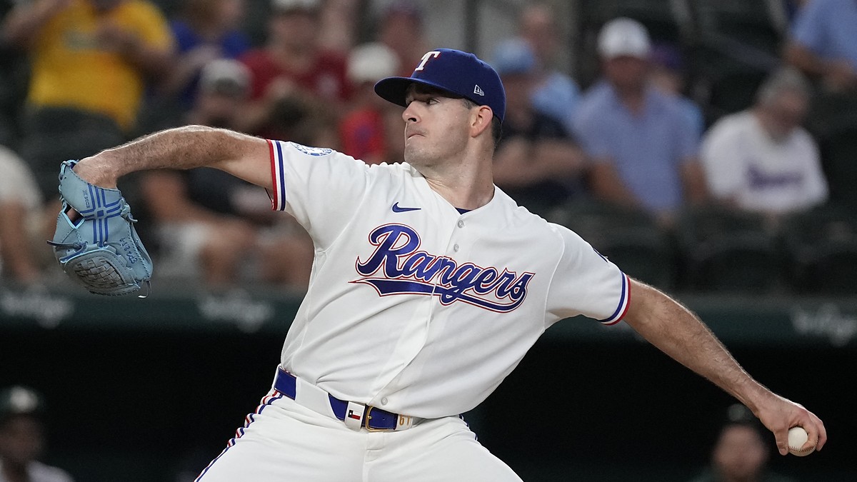 Texas Rangers pitcher Cody Bradford strides toward the plate in his white home uniform at Globe Life Field.
