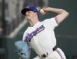 Texas Rangers pitcher Cody Bradford delivers in his white home uniform at Globe Life Field.