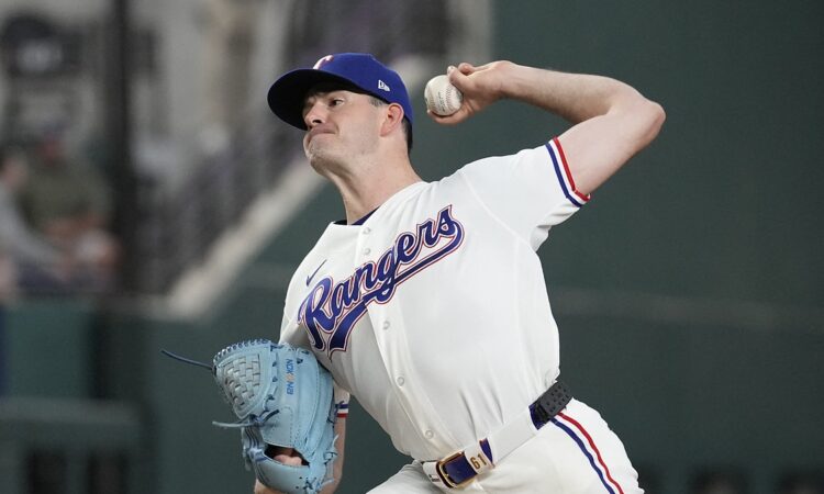 Texas Rangers pitcher Cody Bradford delivers in his white home uniform at Globe Life Field.