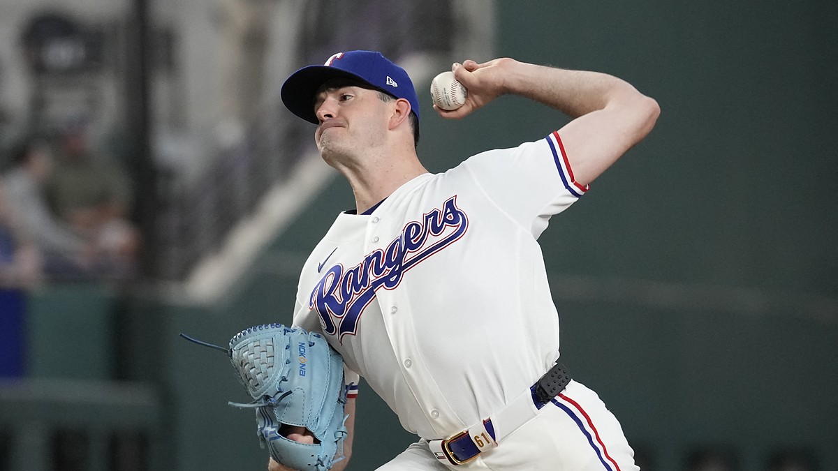 Texas Rangers pitcher Cody Bradford delivers in his white home uniform at Globe Life Field.