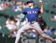 Texas Rangers starting pitcher Cody Bradford raises the ball in his delivery during a game against the Mariners.