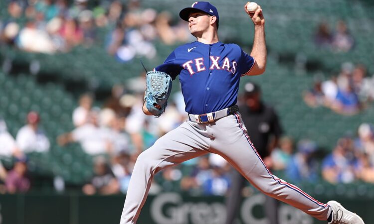 Texas Rangers starting pitcher Cody Bradford raises the ball in his delivery during a game against the Mariners.