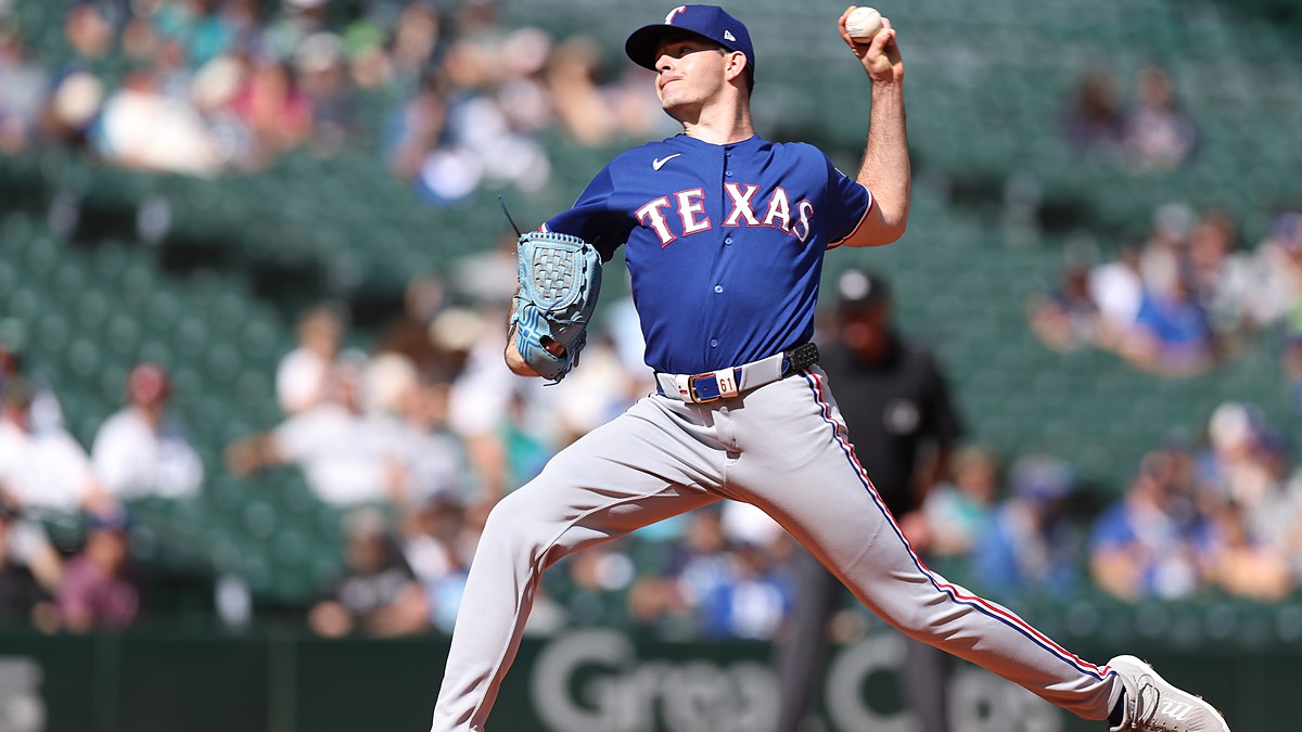Texas Rangers starting pitcher Cody Bradford raises the ball in his delivery during a game against the Mariners.