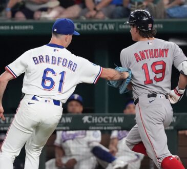 Texas Rangers pitcher Cody Bradford reaches out with his glove to tag Boston Red Sox runner Roman Anthony on the baseline.