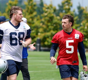 as Cowboys offensive tackle Cole Hutson and quarterback Maverick McIvor jog off the field carrying their helmets.