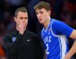 Duke guard Cooper Flagg listens as head coach Jon Scheyer covers his mouth and talks during a stoppage.