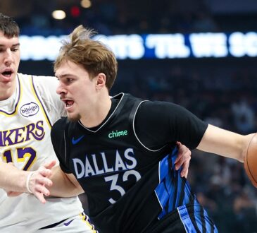 Dallas Mavericks forward Cooper Flagg dribbles with his right hand as Los Angeles Lakers forward Jake LaRavia defends.