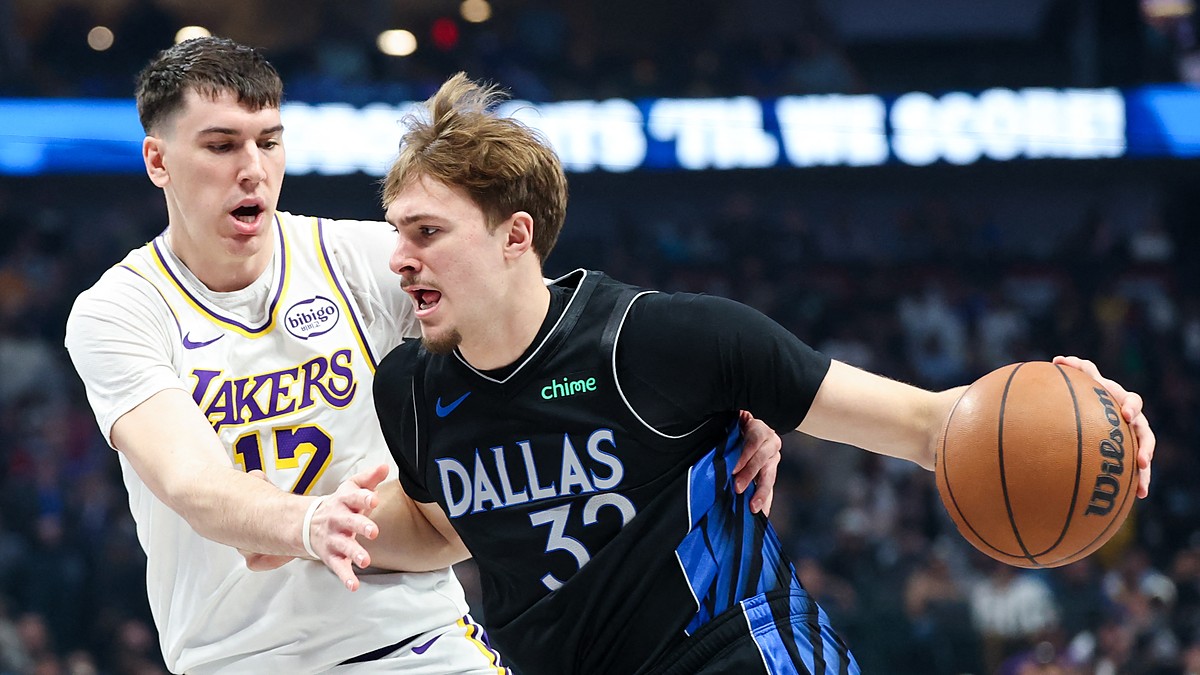 Dallas Mavericks forward Cooper Flagg dribbles with his right hand as Los Angeles Lakers forward Jake LaRavia defends.