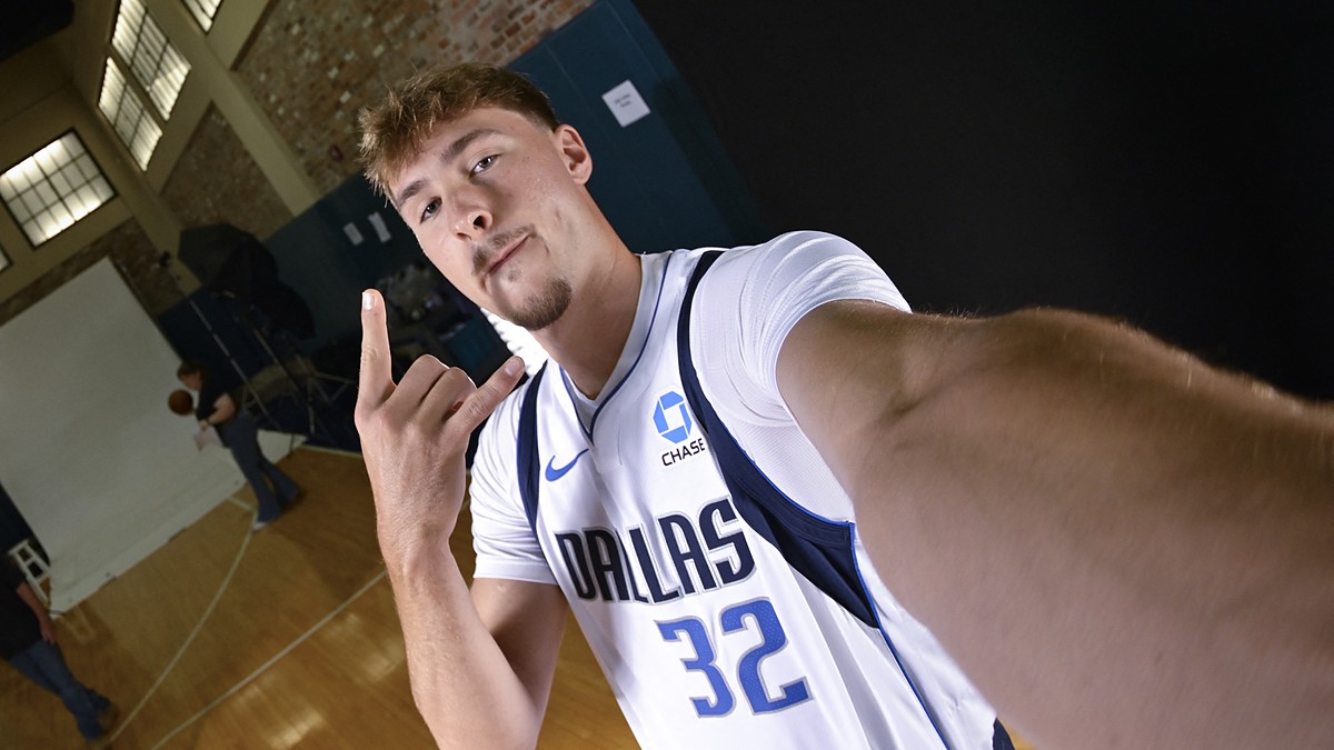 Dallas Mavericks forward Cooper Flagg flashes a hand sign while holding the camera out for a wide-angle selfie.
