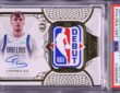 A graded Cooper Flagg rookie card with his autograph and an NBA Debut logo patch in a PSA slab.
