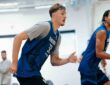 Dallas Mavericks forwards Cooper Flagg and Zaccharie Risacher run up the court side by side in blue practice jerseys.
