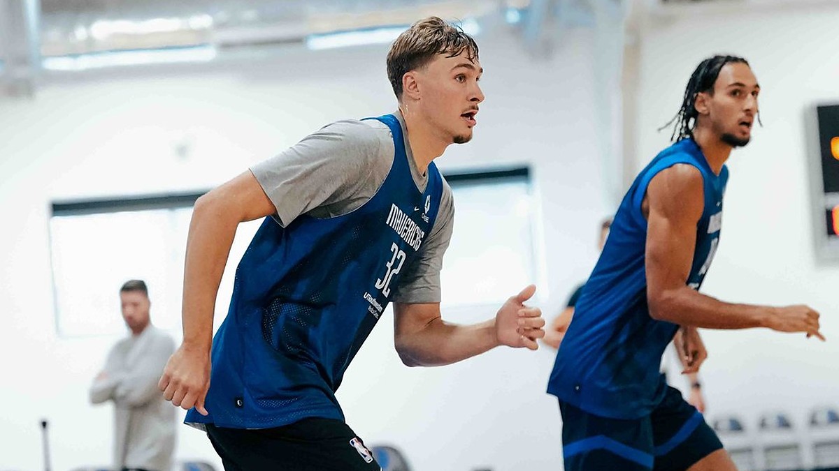 Dallas Mavericks forwards Cooper Flagg and Zaccharie Risacher run up the court side by side in blue practice jerseys.