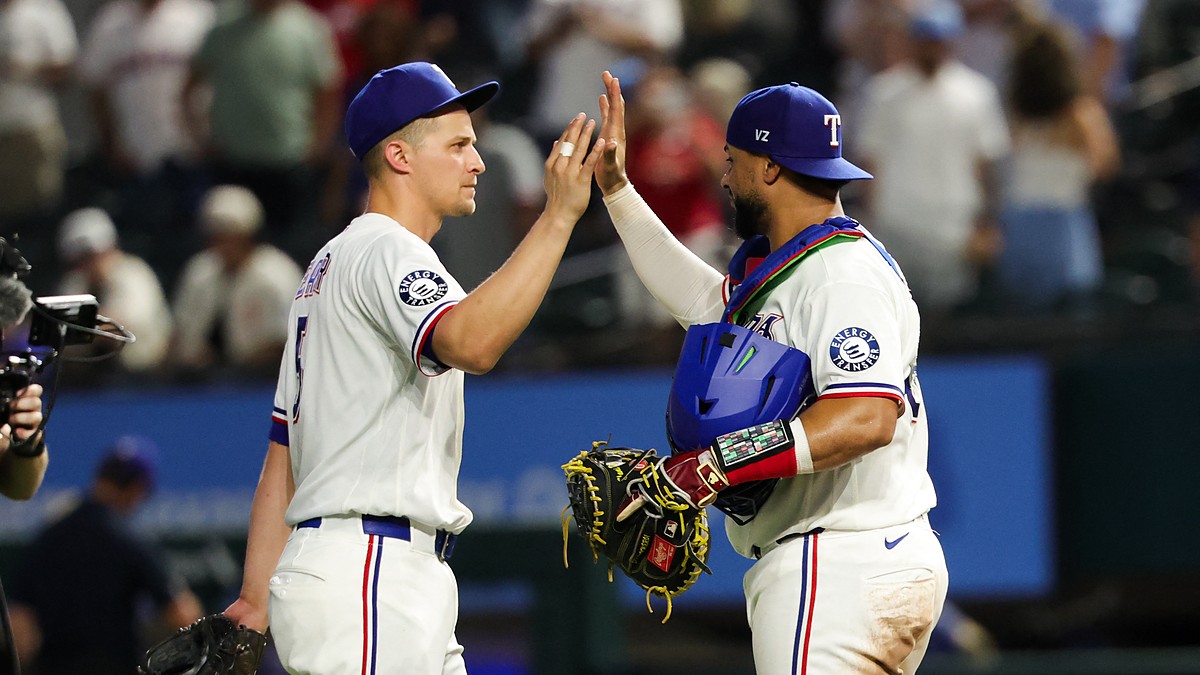 Texas Rangers shortstop Corey Seager, No. 5, high-fives catcher Elias Díaz, No. 35, after a win.