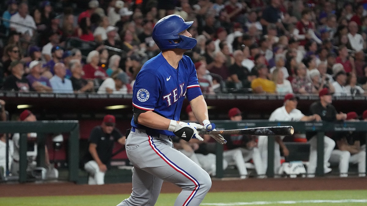 Texas Rangers shortstop Corey Seager follows through on a swing and watches the ball leave the park.