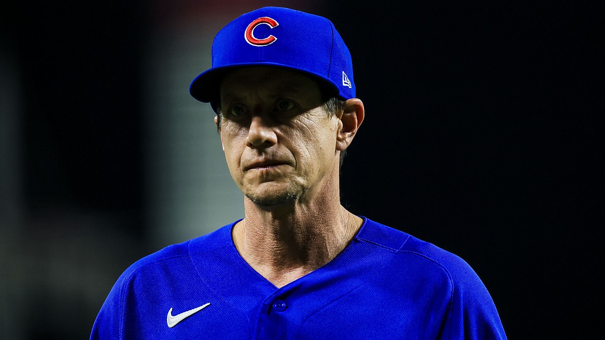 Chicago Cubs manager Craig Counsell walks off the field with a serious expression in a blue Cubs jersey.