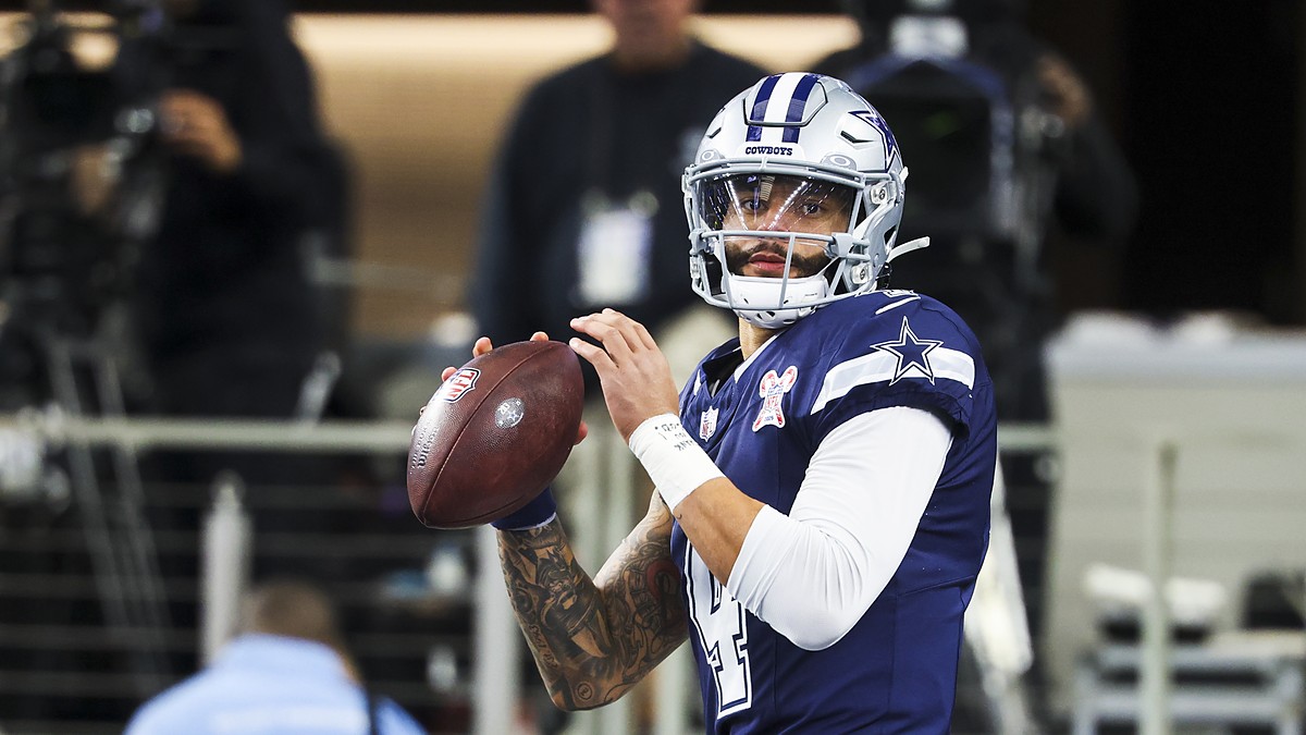 Dallas Cowboys quarterback Dak Prescott holds the ball in both hands during pregame warmups against the Chargers.