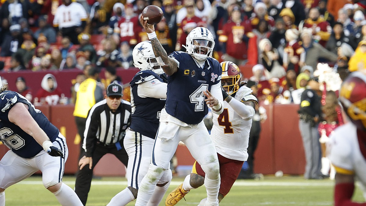 Dallas Cowboys quarterback Dak Prescott throws downfield as Washington Commanders linebacker Frankie Luvu closes in.