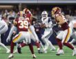 Cowboys quarterback Dak Prescott sets up in the pocket with the football as linemen battle around him.