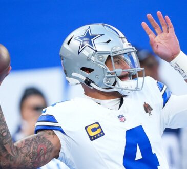 Dallas Cowboys quarterback Dak Prescott throws during warmups before a game at MetLife Stadium.