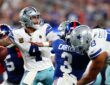 Dallas Cowboys quarterback Dak Prescott winds up to throw as blockers and a Giants rusher fill the pocket.