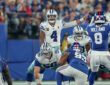 Cowboys quarterback Dak Prescott points out a defender at the line of scrimmage with center Cooper Beebe over the ball.