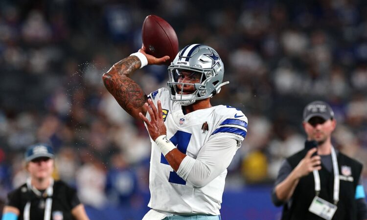 Cowboys quarterback Dak Prescott cocks his arm to throw during warmups before kickoff.