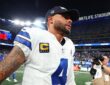 Dallas Cowboys quarterback Dak Prescott walks off the field in a team cap after a loss to the Giants.