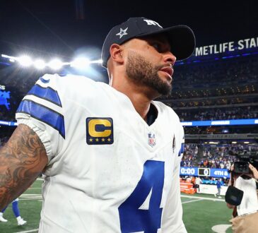 Dallas Cowboys quarterback Dak Prescott walks off the field in a team cap after a loss to the Giants.