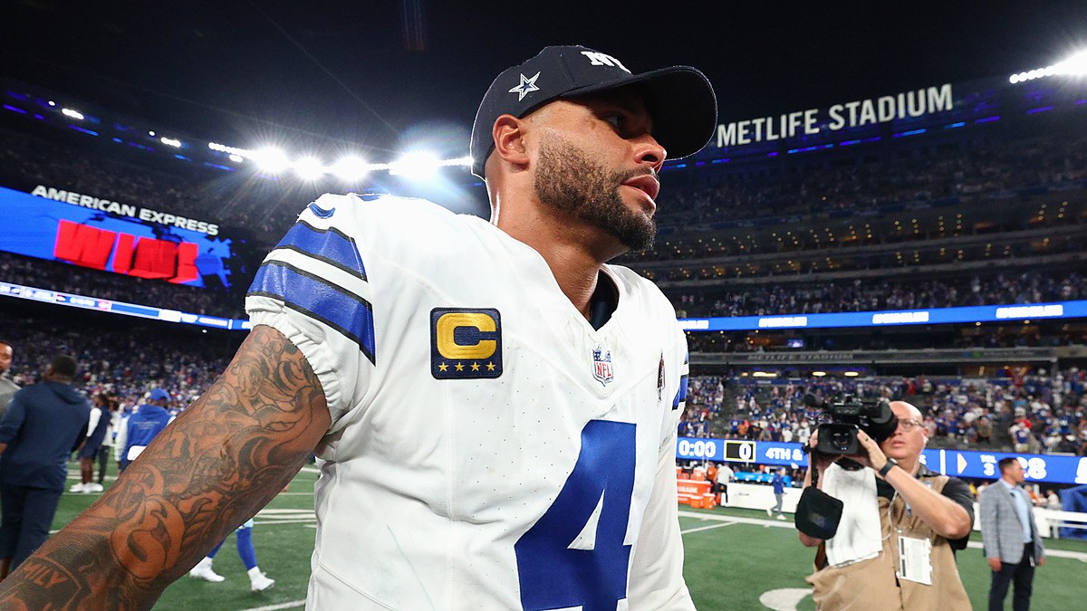 Dallas Cowboys quarterback Dak Prescott walks off the field in a team cap after a loss to the Giants.