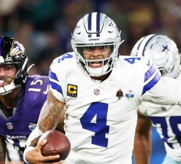 Dallas Cowboys quarterback Dak Prescott runs with the ball as Baltimore Ravens linebacker Michael Green chases him.