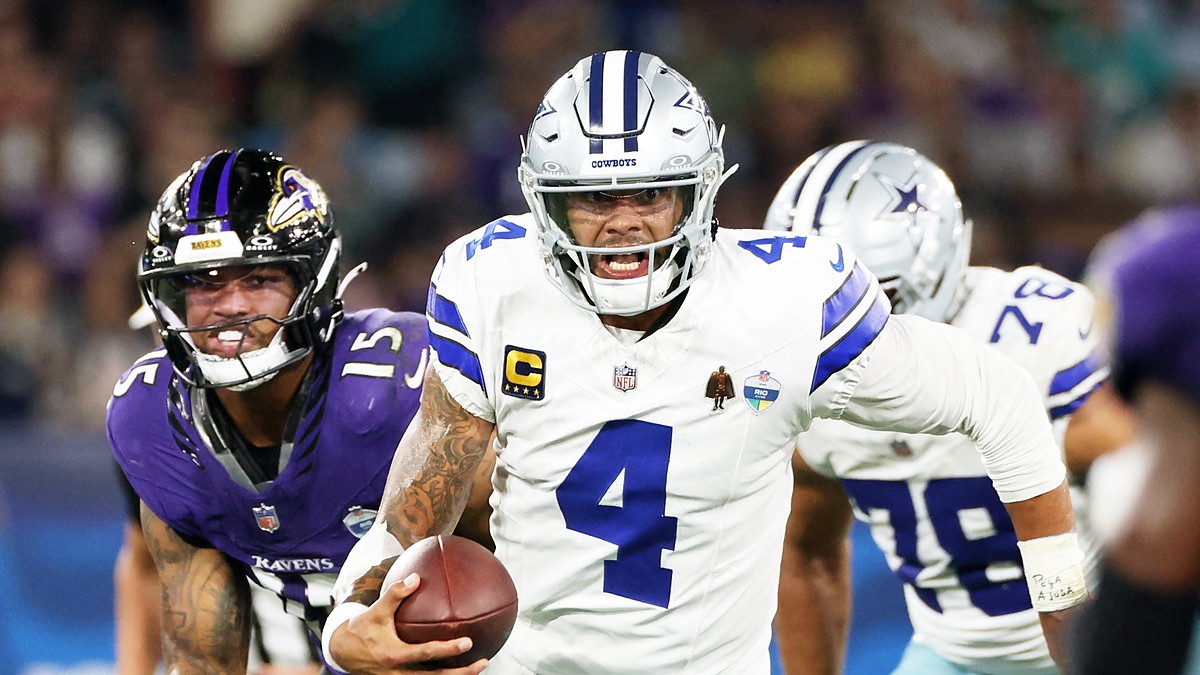 Dallas Cowboys quarterback Dak Prescott runs with the ball as Baltimore Ravens linebacker Michael Green chases him.