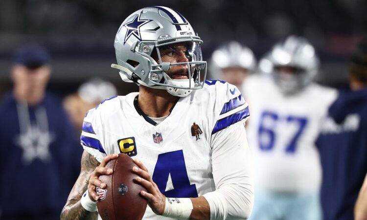 Dallas Cowboys quarterback Dak Prescott holds the ball in a throwing stance during pregame warmups.