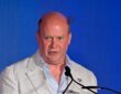 FC Dallas president Dan Hunt speaks at a podium during the National Soccer Hall of Fame induction ceremony.