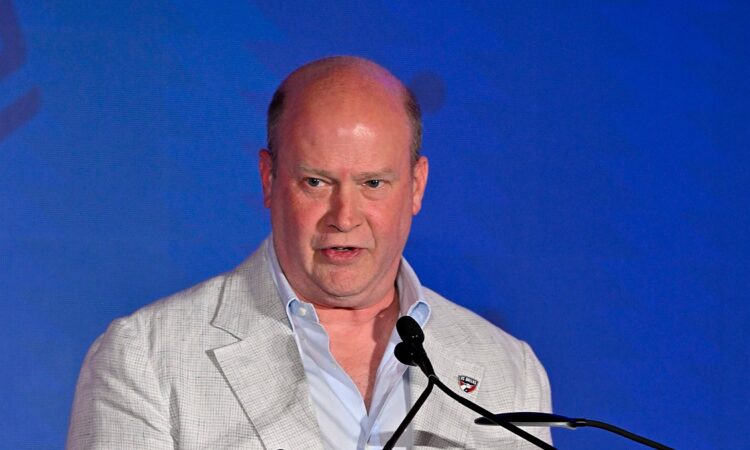 FC Dallas president Dan Hunt speaks at a podium during the National Soccer Hall of Fame induction ceremony.