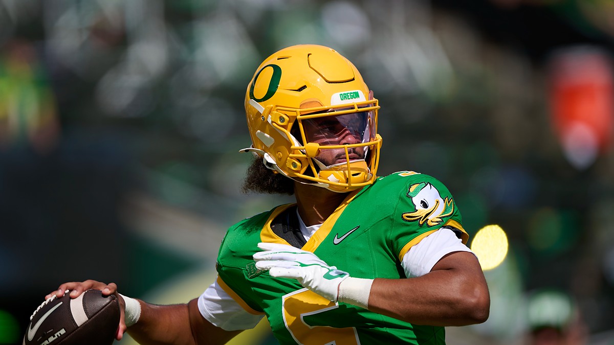Oregon Ducks quarterback Dante Moore, No. 5, cocks his arm to throw during pregame warmups.