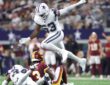Dallas Cowboys linebacker Dee Winters hurdles a tackle as a teammate brings down a Commanders receiver.