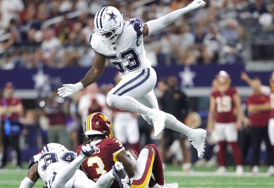 Dallas Cowboys linebacker Dee Winters hurdles a tackle as a teammate brings down a Commanders receiver.