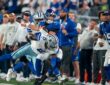 Dallas Cowboys linebacker DeMarvion Overshown drives New York Giants quarterback Jaxson Dart out of bounds near the sideline.