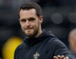 New Orleans Saints quarterback Derek Carr walks the field in a team hoodie during pregame at Caesars Superdome.