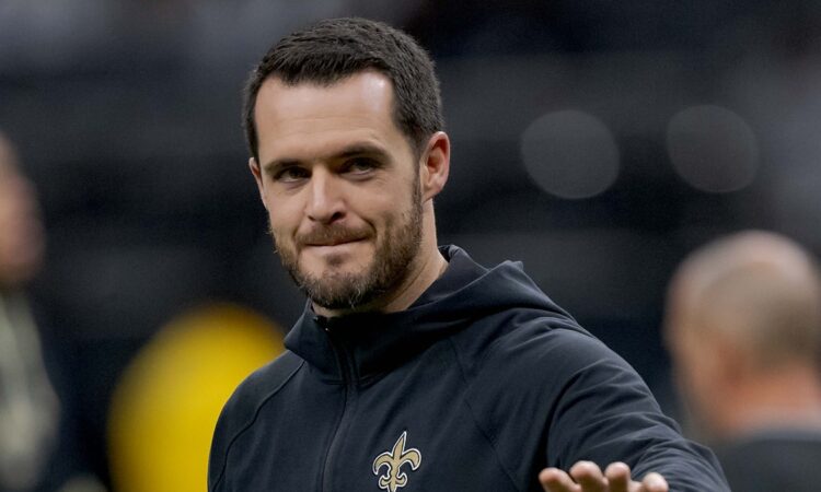 New Orleans Saints quarterback Derek Carr walks the field in a team hoodie during pregame at Caesars Superdome.