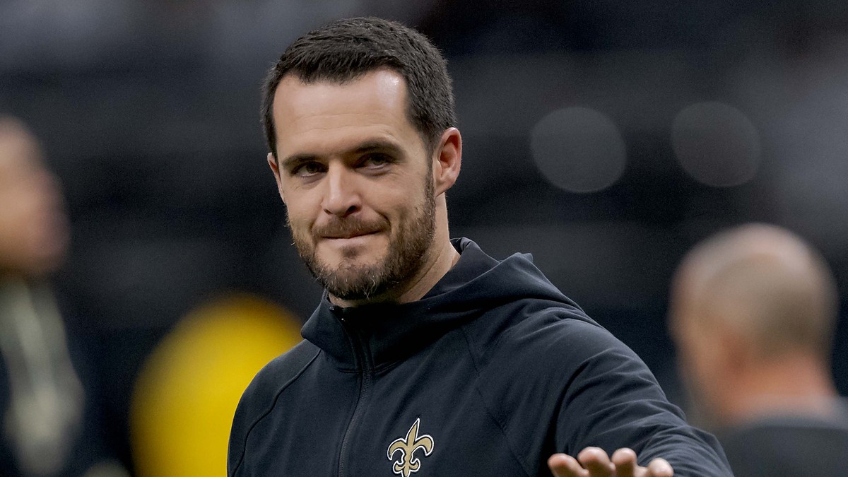 New Orleans Saints quarterback Derek Carr walks the field in a team hoodie during pregame at Caesars Superdome.