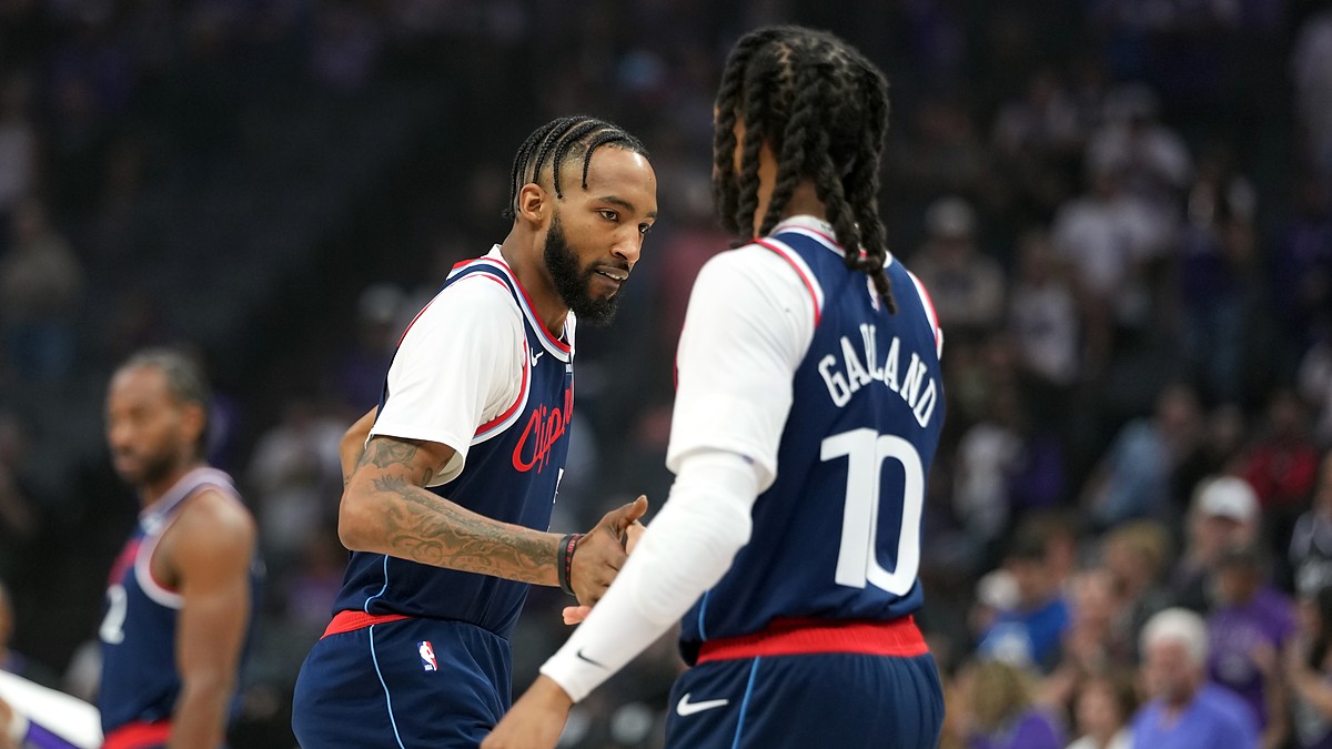 LA Clippers forward Derrick Jones Jr. reaches out to slap hands with teammate Darius Garland before tipoff.