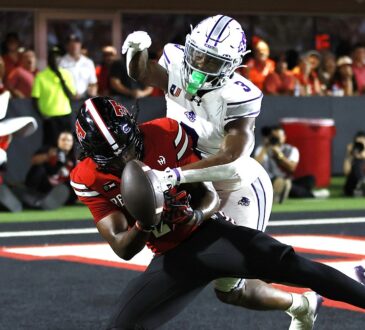 Abilene Christian defensive back Dillon Williams, No. 3, reaches in on Texas Tech tight end Terrance Carter Jr. as the ball comes loose.