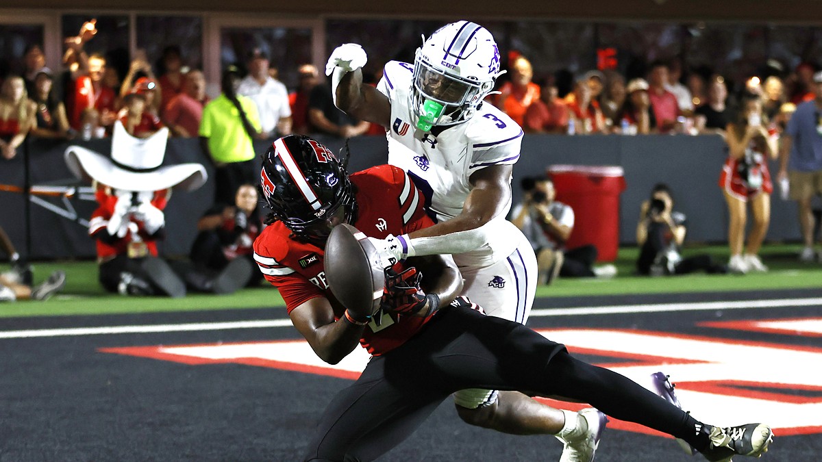 Abilene Christian defensive back Dillon Williams, No. 3, reaches in on Texas Tech tight end Terrance Carter Jr. as the ball comes loose.
