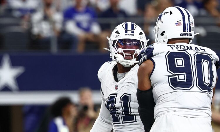 Dallas Cowboys defensive end Donovan Ezeiruaku smiles as he celebrates face to face with teammate Solomon Thomas.